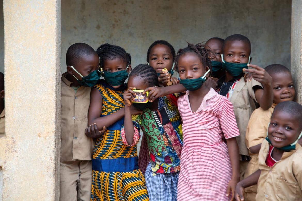Children playing in front of their classroom in Guinea.