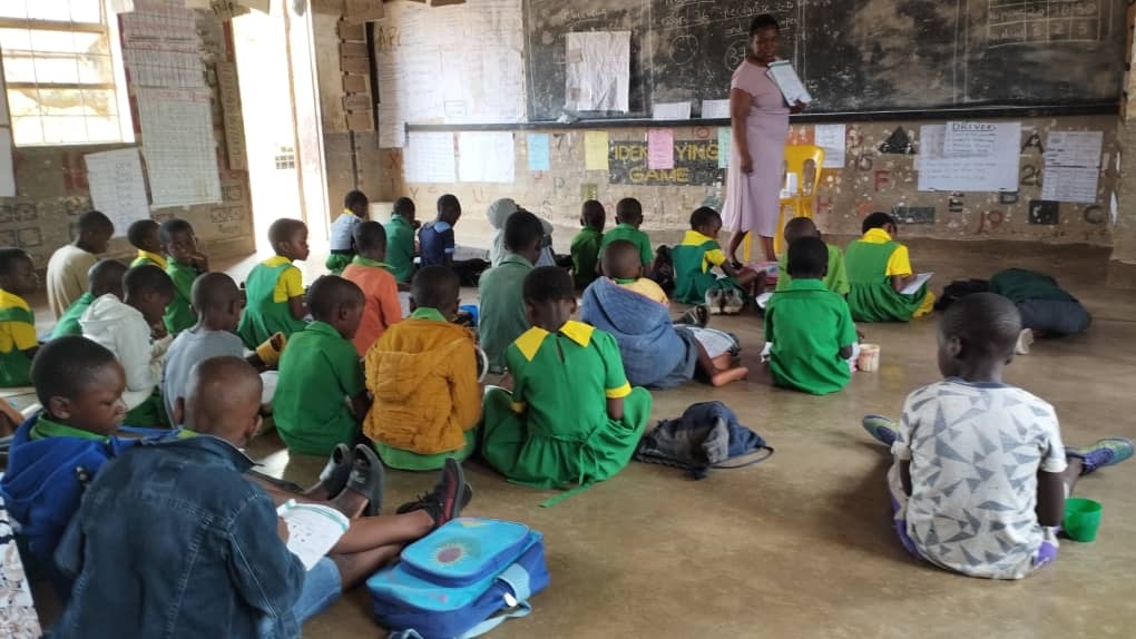 Students and their teacher in class at Yepa Primary School, Dzenza Zone, Lilongwe, Malawi. Credit: Cambridge Education